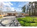 Beautiful brick home with an attached carport and well-maintained lawn, offering great curb appeal and covered parking at 2540 Deal Rd, Mooresville, NC 28115