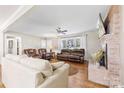 Bright and spacious living room featuring hardwood floors, a brick fireplace, and large windows for natural light at 2540 Deal Rd, Mooresville, NC 28115