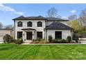 Charming two-story home with manicured lawn, dark window trim and brick facade at 300 Mammoth Oaks Dr, Charlotte, NC 28270