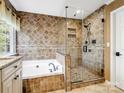 Luxurious bathroom with a soaking tub, glass-enclosed shower, and tiled walls at 3140 S Legacy Park Blvd, Fort Mill, SC 29707