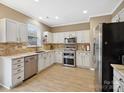 Bright kitchen featuring stainless steel appliances, white cabinets, and a tile backsplash at 3140 S Legacy Park Blvd, Fort Mill, SC 29707