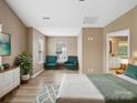 Bright main bedroom with sitting area, neutral walls, wood floors, and attached bathroom at 3140 S Legacy Park Blvd, Fort Mill, SC 29707