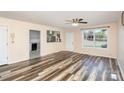 Cozy living room features wood-look floors, a ceiling fan, and views into kitchen at 400 E 1St St, Cherryville, NC 28021