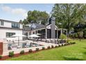 Resort-style pool area with ample seating, stylish umbrellas, and lush landscaping at 401 Woodland St, Davidson, NC 28036