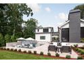 A backyard oasis with a refreshing pool, lounge chairs, and a well-designed patio area at 401 Woodland St, Davidson, NC 28036