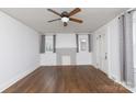 Bright living room featuring hardwood floors, fresh paint, a ceiling fan, and a decorative fireplace at 402 Pickens Ct, Rock Hill, SC 29730