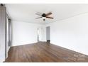 Spacious living room featuring hardwood floors, fresh paint, a ceiling fan, and multiple entry points at 402 Pickens Ct, Rock Hill, SC 29730