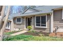 Inviting front entrance featuring a well-maintained yard, mature trees, and a charming exterior at 413 19Th Avenue Ne Ct, Hickory, NC 28601