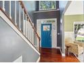 Bright foyer features beautiful hardwood floors and a blue front door at 4130 Brownwood Nw Ln, Concord, NC 28027