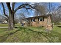 Quaint brick home with mature tree shading a lush lawn and established landscaping at 519 Locust St, Rock Hill, SC 29730