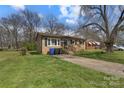 Inviting single-story brick home featuring a well-manicured lawn and concrete driveway at 519 Locust St, Rock Hill, SC 29730