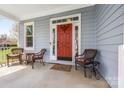 Inviting front porch with cozy seating, a stylish front door, and great natural light at 5601 Underwood Ave, Charlotte, NC 28213