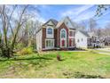 Traditional brick and siding home with manicured lawn and mature trees in a residential neighborhood at 6916 Sardis Green Ct, Charlotte, NC 28270