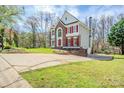 Brick and siding home boasts an attached garage and driveway, complemented by a lush green lawn at 6916 Sardis Green Ct, Charlotte, NC 28270