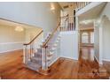 Inviting foyer with hardwood floors, staircase with white railings, and a chandelier, creating an elegant entrance at 6916 Sardis Green Ct, Charlotte, NC 28270