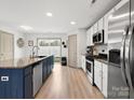Modern kitchen features stainless steel appliances, white cabinets, and center island at 8260 Waxhaw Hwy, Waxhaw, NC 28173