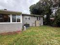 Spacious backyard featuring a brick exterior and an outbuilding for storage at 842 E Woodlawn Rd, Charlotte, NC 28209
