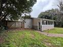 This home features a well-maintained backyard with a brick pathway and ample space at 842 E Woodlawn Rd, Charlotte, NC 28209
