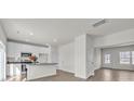 A bright kitchen featuring white cabinets, stainless steel appliances, and an eat-in bar area with views to the dining room at 126 Orville Rd, Statesville, NC 28677