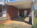 Covered carport providing parking and shelter, attached to a brick home at 1403 Oakwood Ave, Kannapolis, NC 28081