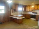 Cozy kitchen with knotty pine cabinets and lots of natural light at 1403 Oakwood Ave, Kannapolis, NC 28081