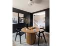 Cozy dining room featuring a round wooden table, black accent wall, and modern decor at 1518 Levy Way, Charlotte, NC 28205