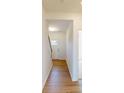 Bright hallway features hardwood flooring, leading to the front door and stairs, with a view into another room at 1829 Augustine St, Monroe, NC 28112