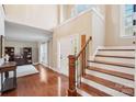 Sunlit foyer with a grand staircase and hardwood floors provides a warm welcome to guests at 1916 Dugan Dr, Charlotte, NC 28270