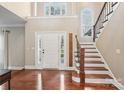 Bright foyer with hardwood floors, staircase, and a soaring ceiling welcomes you home at 1916 Dugan Dr, Charlotte, NC 28270