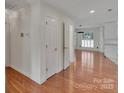 Bright entryway featuring hardwood floors, white trim, and multiple doorways at 1963 Wexford Ct, Gastonia, NC 28054