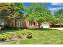 Well-manicured lawn and garden beds add to the curb appeal of this brick home at 1963 Wexford Ct, Gastonia, NC 28054