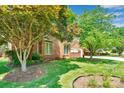 Lush front yard featuring mature trees and landscaped garden beds at 1963 Wexford Ct, Gastonia, NC 28054