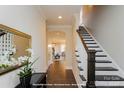 Inviting foyer with hardwood floors, staircase, and elegant decor at 19724-B School St, Cornelius, NC 28031