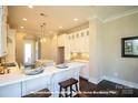 Bright kitchen with white cabinetry, center island, and modern appliances at 19732-B School St, Cornelius, NC 28031