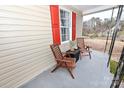 Covered front porch featuring outdoor seating with stylish accent furniture and ample natural light at 2010 Simmons St, Gaston, NC 28052