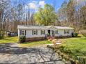 Wide aerial view of a single-story home featuring a brick foundation, green lawn, and storage shed in the yard at 230 Valley View Dr, Clover, SC 29710