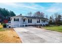 Inviting home boasts a ramp for accessibility, a large driveway, and a cozy, covered front porch at 2561 Ellys St, Lincolnton, NC 28092