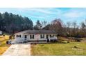 Charming house with a ramp, American flag, and well-manicured lawn, offering a welcoming curb appeal at 2561 Ellys St, Lincolnton, NC 28092