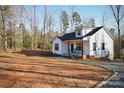 Charming single-story home boasts a welcoming front porch and serene wooded surroundings at 357 Woodrun Dr, Mount Gilead, NC 27306