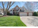 Charming brick home features a well-manicured lawn and attached two car garage at 4300 Pointe Norman Dr, Sherrills Ford, NC 28673