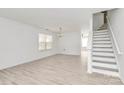 Bright living room featuring new floors, a staircase, a chandelier, and plenty of natural light at 4513 Staffordshire Ln, Charlotte, NC 28213