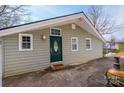 Home exterior shows siding and front entry with porch light and updated green front door at 4846 Midway Sand Rd, Hickory, NC 28601