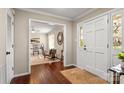 Inviting foyer with hardwood floors, a white door, and a glimpse into a cozy living space at 5217 Camilla Dr, Charlotte, NC 28226