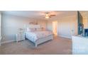 Spacious main bedroom featuring a comfortable bed, carpeted floor, and neutral color palette at 5413 Austin Rd # 4, Monroe, NC 28112