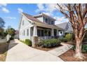 Craftsman-style home with welcoming porch, stone accents, mature landscaping and a private driveway at 643 Mcalway Rd, Charlotte, NC 28211