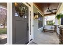 Charming porch featuring a cozy bench, stylish lighting, stained wood ceiling, and decorative wreath at 643 Mcalway Rd, Charlotte, NC 28211