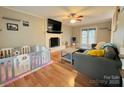 Bright living room featuring hardwood floors, a brick fireplace, and access to the backyard at 7025 Spring Morning Ln, Charlotte, NC 28227