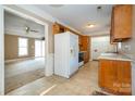 Spacious kitchen featuring wooden cabinets, tile floors and appliances at 82 Paddington Sw Dr, Concord, NC 28025