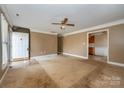 Open living room space with a ceiling fan and access to kitchen at 82 Paddington Sw Dr, Concord, NC 28025