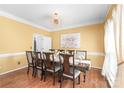 Formal dining room featuring hardwood floors, elegant decor, and a dining table set for eight at 111 Harris Farm Rd, Mooresville, NC 28115